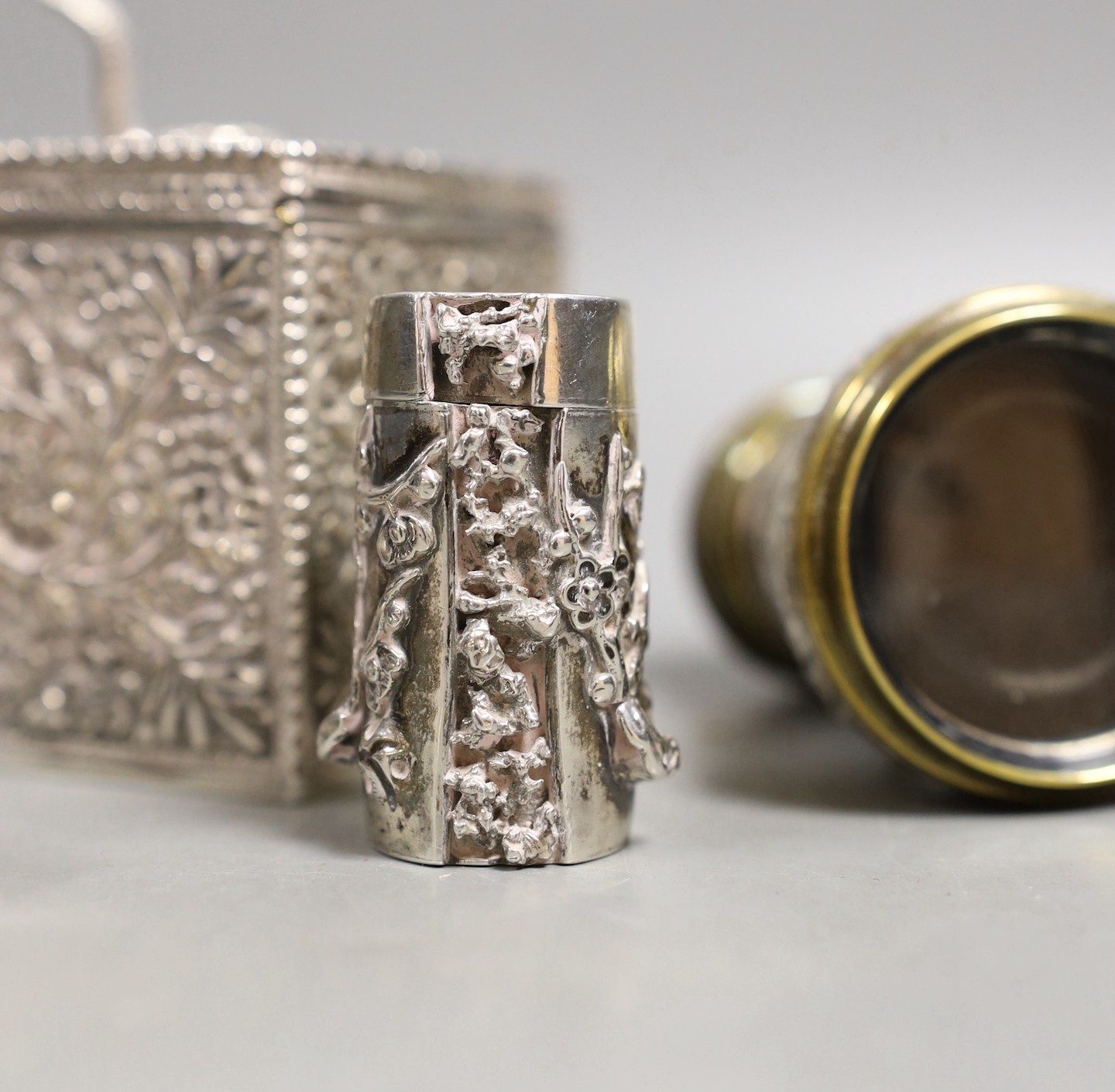 A late Victorian Indian silver box and cover, with serpent finial, import marks for London, 1898, 9cm, a Chinese Export white metal condiment, a pair of late Victorian silver mounted opera glasses and a white metal paras
